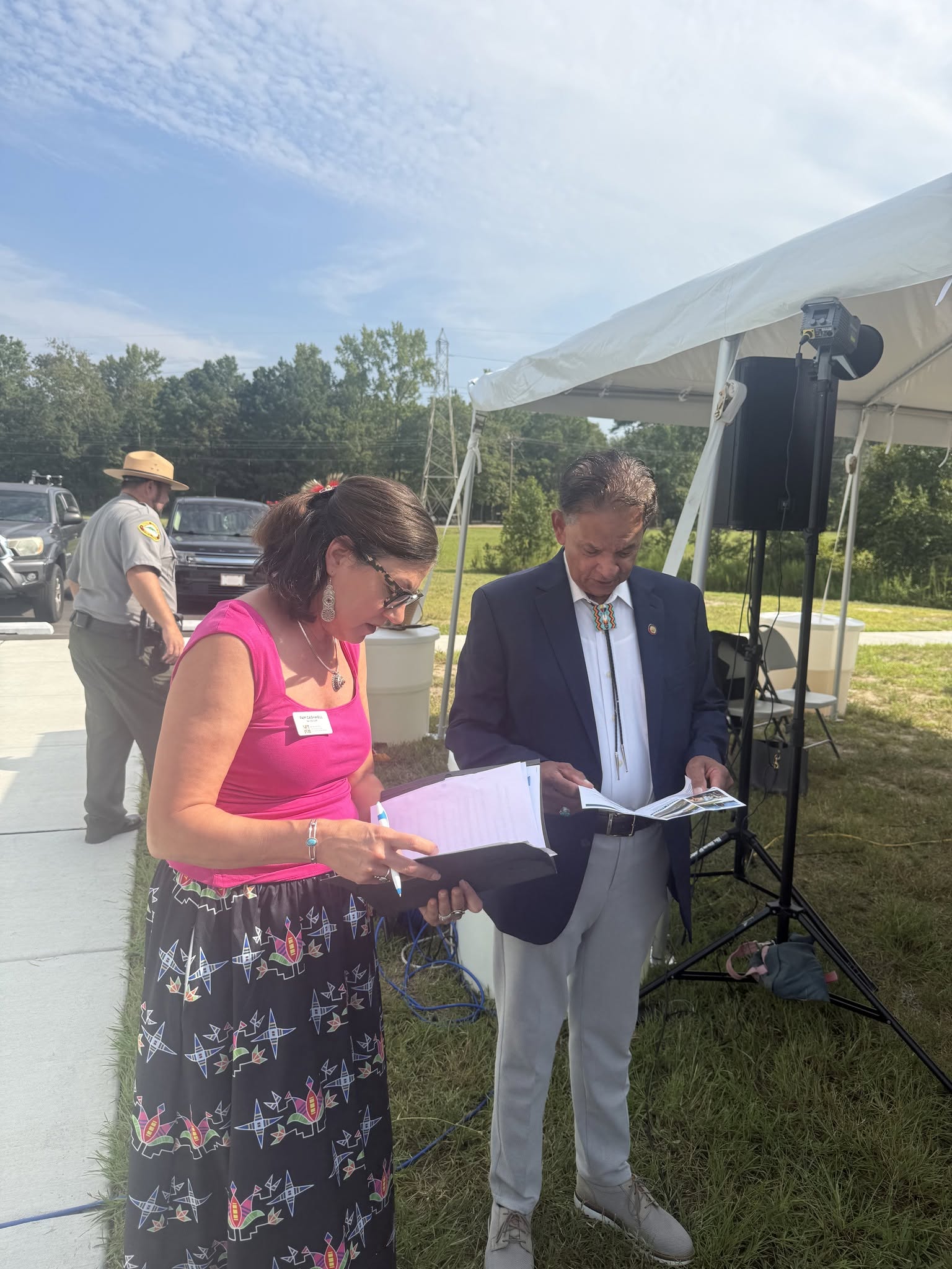 Charles Graham reviewing event materials with a community volunteer